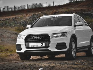 white audi a 4 on dirt road during daytime